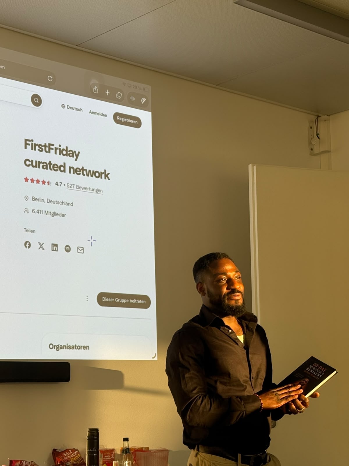 Temitope Okunjolu holding the 60-Day Spiritual and Business Action Planner